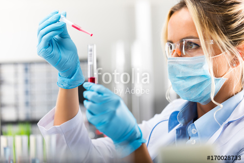 Young attractive female scientist researching in the laboratory